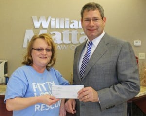 William Mattar presents shelter donation to Kerri Saxer of Pitty Love Rescue