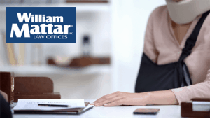 injured woman filling out insurance claim paperwork
