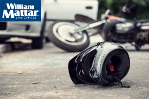 helment on ground with motorcycle crash in background