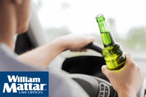 Man drinking a beer while driving