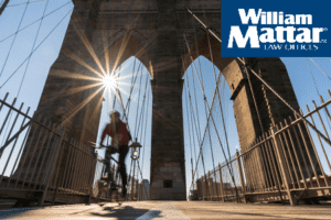 Man Riding Bike on Brooklyn Bridge