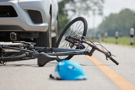 bike in road after accident with a car